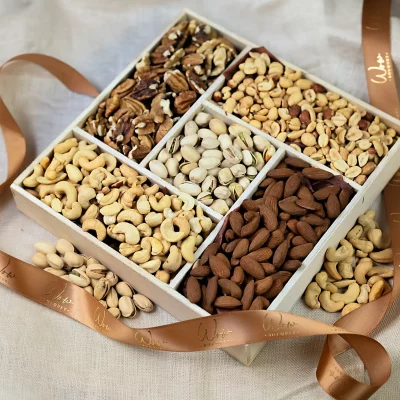 A luxurious 10x10 gift box filled with assorted nuts including cashews, almonds, peanuts, pecans, and pistachios, neatly arranged and ready for gifting.