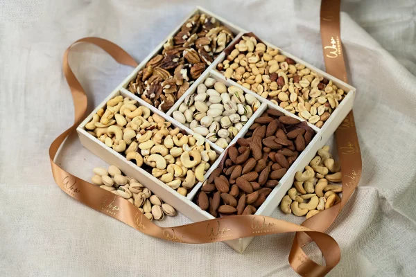 A luxurious 10x10 gift box filled with assorted nuts including cashews, almonds, peanuts, pecans, and pistachios, neatly arranged and ready for gifting.