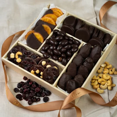 A luxurious 10x10 inch Chocolate Decadence Gift Box containing chocolate mendiants, chocolate covered almonds, Oreos, orange slices, and dates.