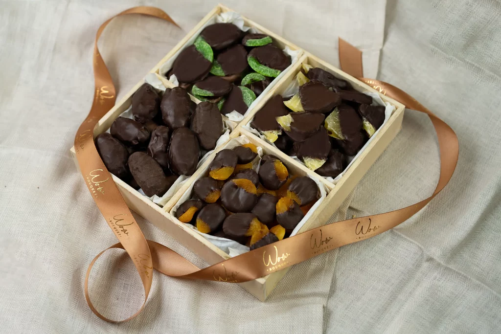 Dark Chocolate Dried Fruit Gift Box with a variety of chocolate-covered dried fruits, including kiwi, Medjool dates, pineapples, and apricots, in a 10x10 box.