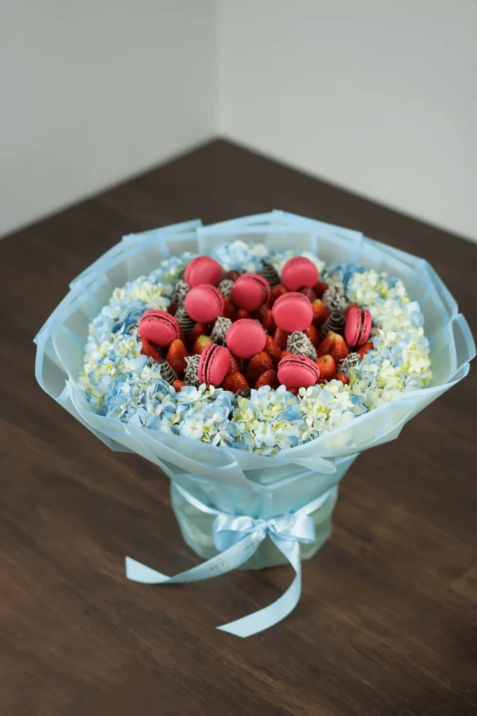 Depicting a charming arrangement of fresh strawberries and lush hydrangea blooms, combining natural beauty and vibrant colors.