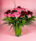 Elegant vase filled with 2 dozen pink and 2 dozen red roses for a romantic gesture