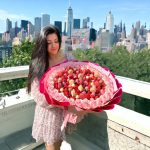 Romantic and edible art with pink roses and chocolate-dipped strawberries