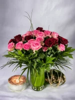 48 vibrant pink and red roses arranged meticulously in a stylish vase