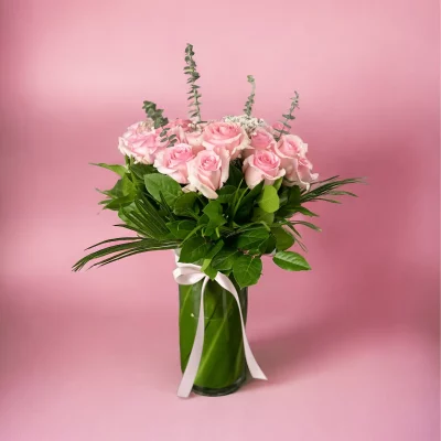 A gorgeous bouquet of 24 long-stemmed pink roses, gracefully arranged.