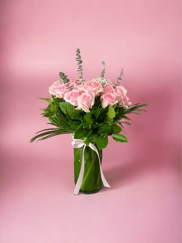 A gorgeous bouquet of 24 long-stemmed pink roses, gracefully arranged.