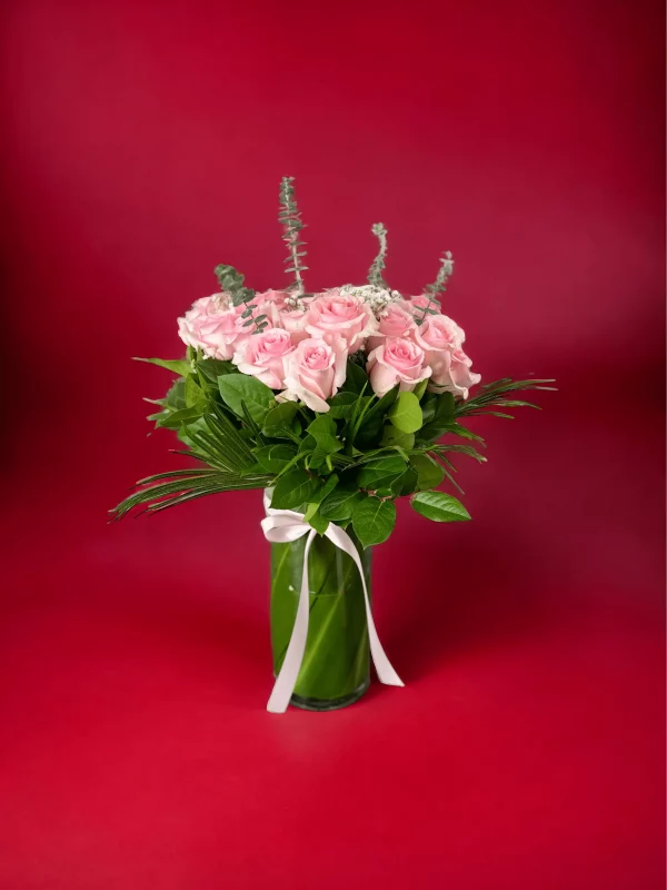 A full, vibrant bouquet of pink roses, artfully arranged for a stunning display.