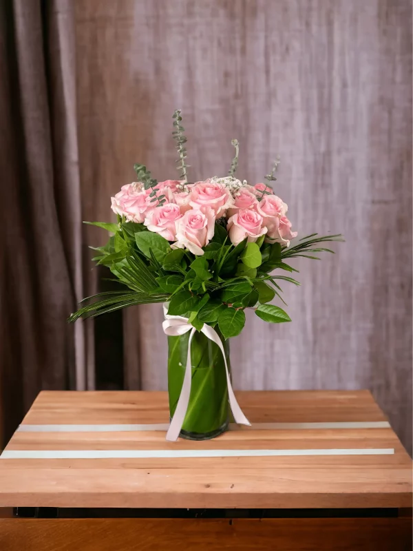 Luxurious floral arrangement of two dozen fresh pink roses for delivery.