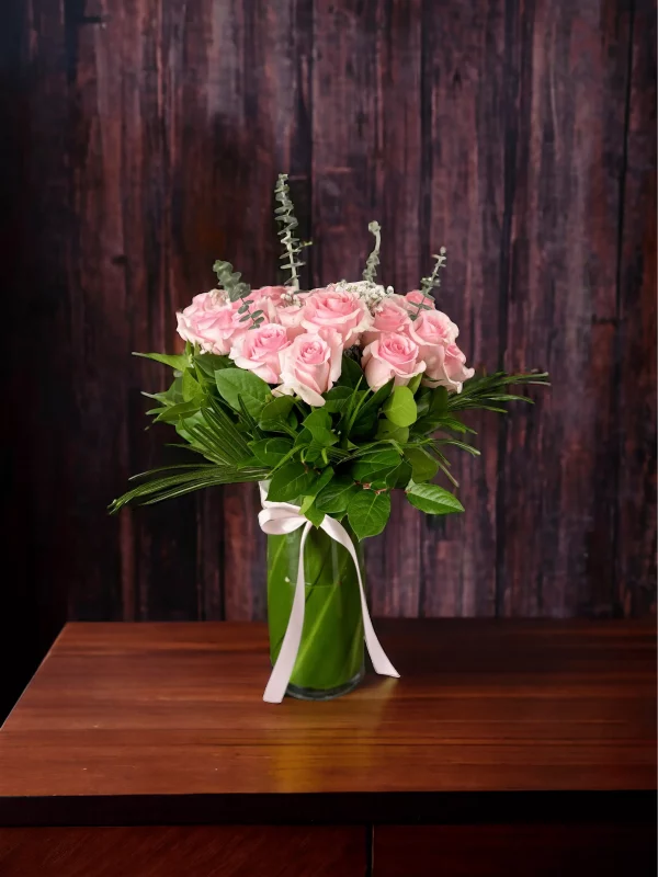 Lush bouquet of 2 dozen pink roses, symbolizing grace and admiration.