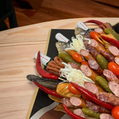 An arrangement of jerky and dried meat sticks, styled like a traditional flower bouquet, tied with a rustic twine bow.