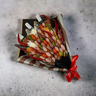 A bouquet of various grilled meats, including steak, chicken, and sausage, artistically arranged and skewered like flowers.