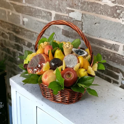 A delightful fruit basket filled with an assortment of fresh, seasonal fruits and a variety of mixed nuts, arranged in a hand-woven basket.