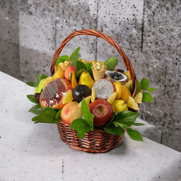 A colorful and inviting fruit basket overflowing with citrus fruits, pears, and grapes, accompanied by a selection of gourmet nuts in a decorative tin.