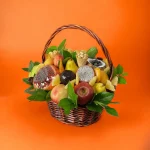 An elegant fruit basket featuring exotic fruits like kiwi and mango, alongside a rich collection of roasted and salted nuts.