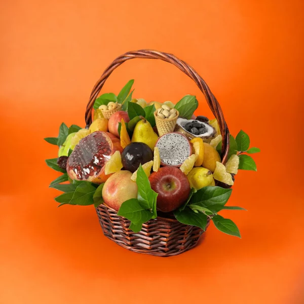 An elegant fruit basket featuring exotic fruits like kiwi and mango, alongside a rich collection of roasted and salted nuts.