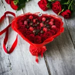 A romantic Heart-Shaped Strawberry Bouquet, combining vibrant flowers, fresh strawberries, chocolate hearts, and macarons for a visually stunning and tasty gift.