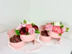 Sophisticated gift package displaying pink and white peonies with strawberries covered in silky chocolate.