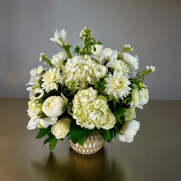 Timeless white flower bouquet featuring roses, hydrangeas, and peonies.