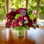 Beautiful red floral arrangement with hydrangeas, roses, and peonies.