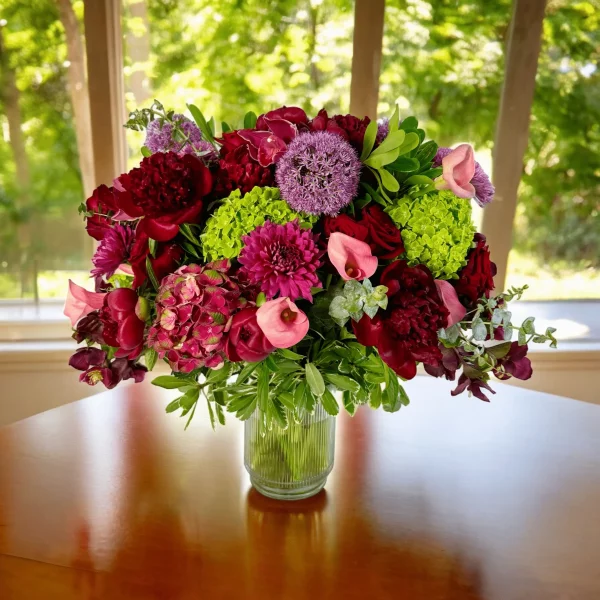 Beautiful red floral arrangement with hydrangeas, roses, and peonies.