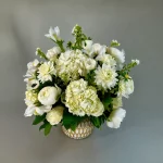 Stunning vase of white roses, hydrangeas, and peonies.