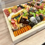 Festive charcuterie box featuring a mix of sweet and savory items, ideal for Christmas gatherings