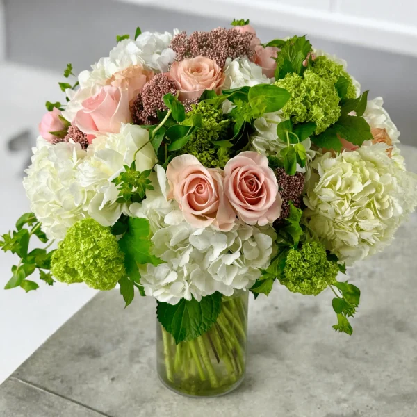 Hydrangea and rose arrangement in a vase for delivery in NYC