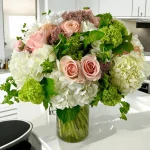 Large hydrangea and rose display in a vase for special occasions