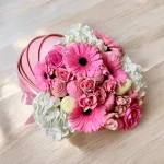 Baby-themed gift box with floral arrangement and chocolate strawberries