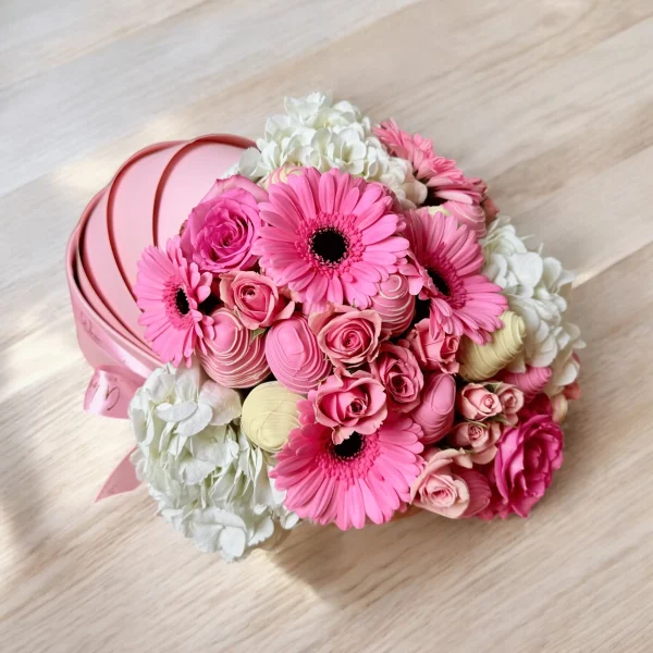 Baby-themed gift box with floral arrangement and chocolate strawberries