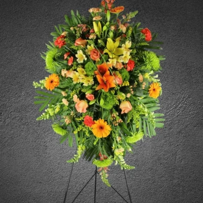 Full view of Golden Remembrance Funeral Standing Spray on an easel.