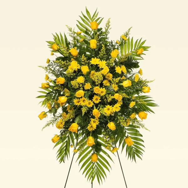 Detailed look at yellow roses and solidago in a heartfelt spray.