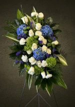 Elegant white roses and carnations in a standing spray.