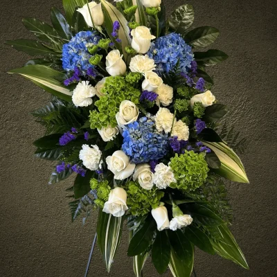 Elegant white roses and carnations in a standing spray.