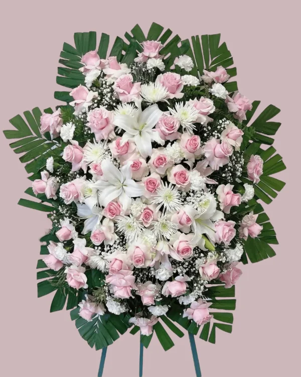 Side angle of pink and white flowers in a funeral standing spray.