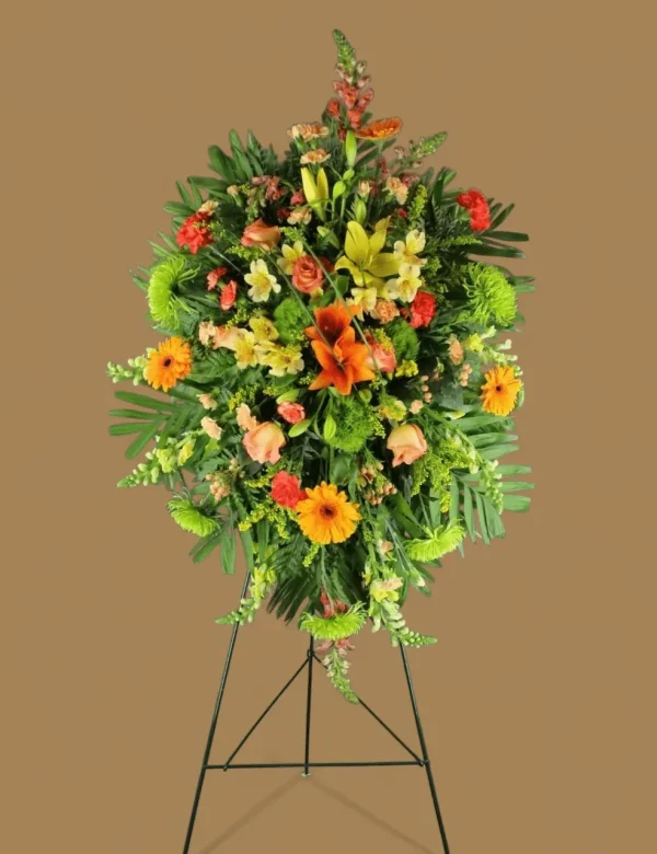 Side angle showcasing snapdragons and mums in a floral tribute.