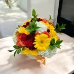 Elegant anniversary flower arrangement with roses, hydrangeas, and carnations.