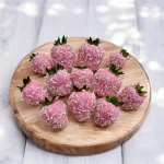 Half dozen pink-tinted white Belgian chocolate strawberries with coconut topping