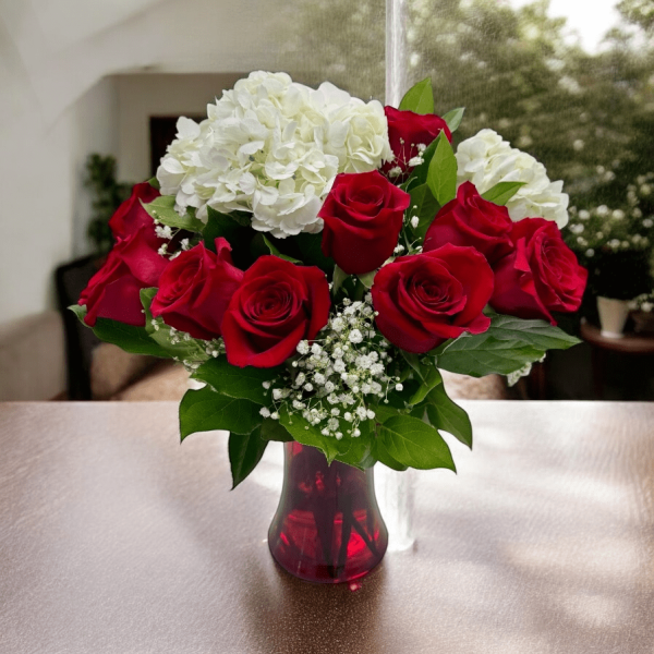 Romantic combination of red roses with white hydrangeas