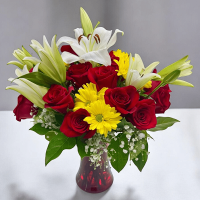 Classic red roses paired with lilies and daisies