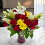 Fresh daisies complementing lilies and roses in a vase