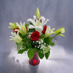 Close-up of lilies and roses arrangement