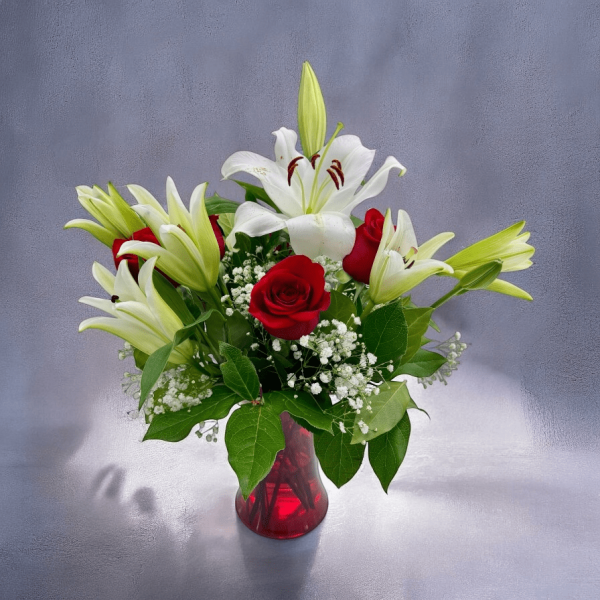 Close-up of lilies and roses arrangement