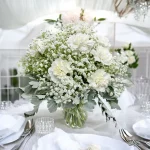 Soft pastel carnations beautifully arranged in a vase