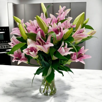 Delicate pink lilies displayed in the kitchen