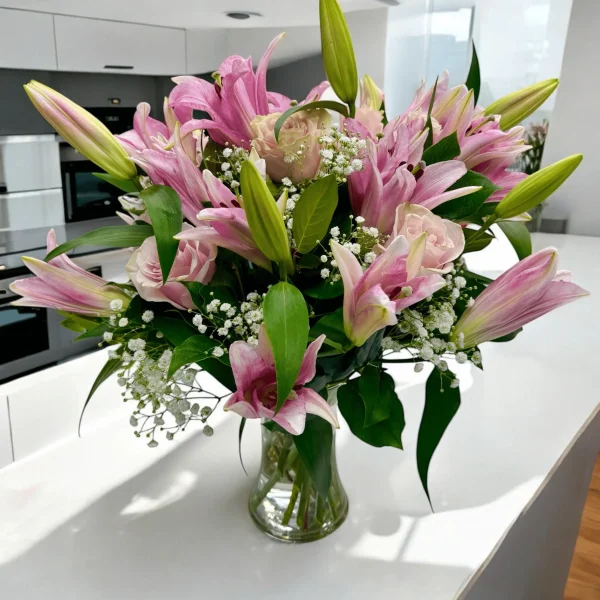 Hand-arranged pink lilies and pink roses for local delivery