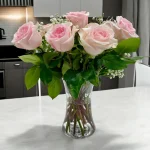 Fresh pink roses placed in a simple vase