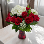 Ready-for-delivery bouquet featuring red roses and hydrangeas