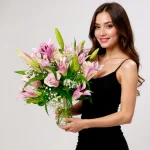 Fresh mixed flower arrangement featuring lilies, roses, and baby’s breath