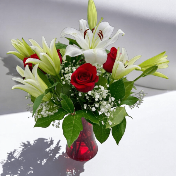 Hand-arranged bouquet of lilies and roses